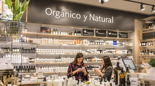 Two women compare organic and natural skincare in a well-lit beauty store aisle