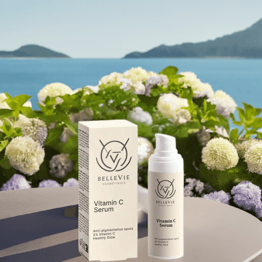 Woman applying Vitamin C serum to cheeks with glowing skin