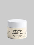 A white cosmetic jar with a cream-colored label reading 'Deep Cleanse Scalp Scrub, Rosemary / Mint' on a light gray background.