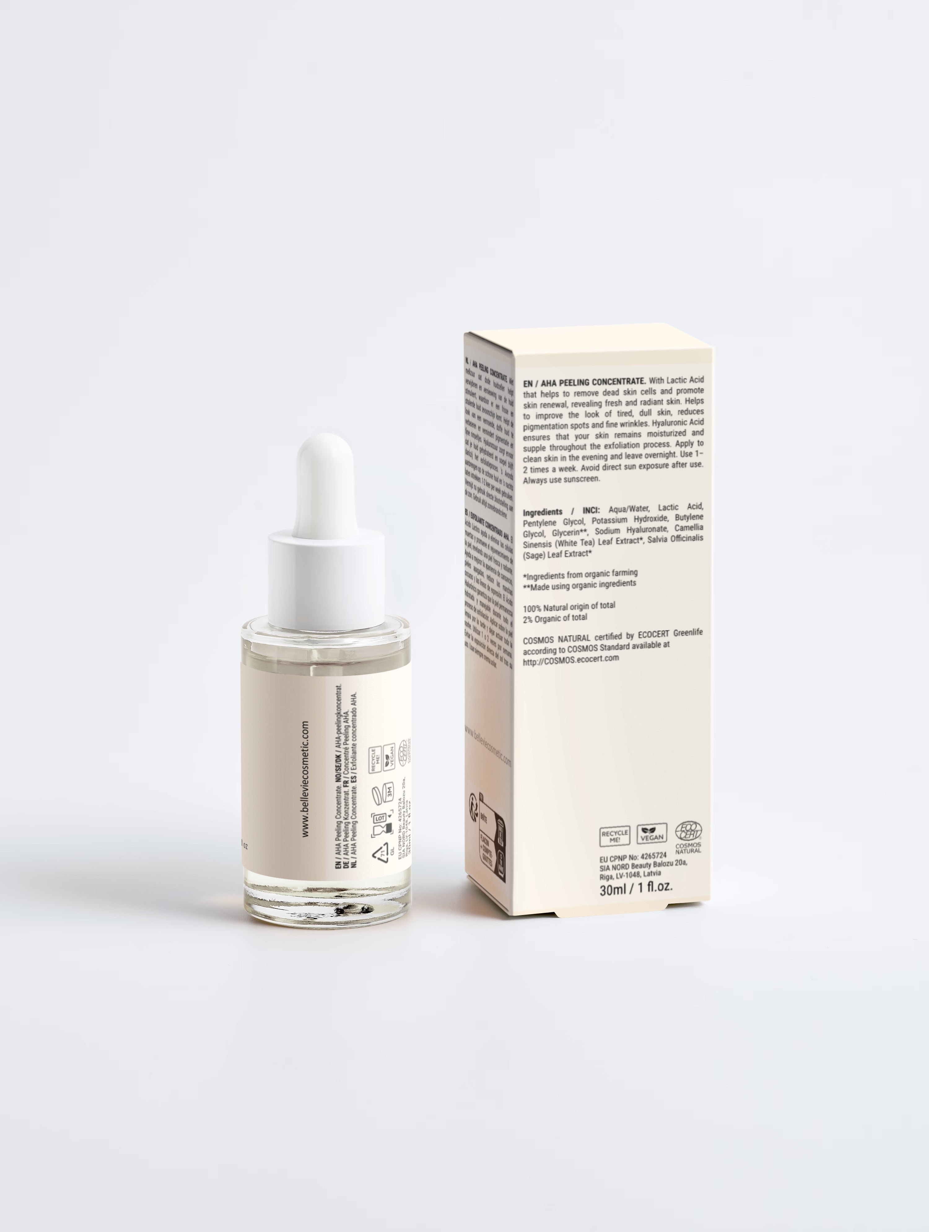 A clear glass dropper bottle with a white cap stands next to its cream-colored product box on a light gray background. The box is shown from the side with printed text, and the bottle has a white label with small text.