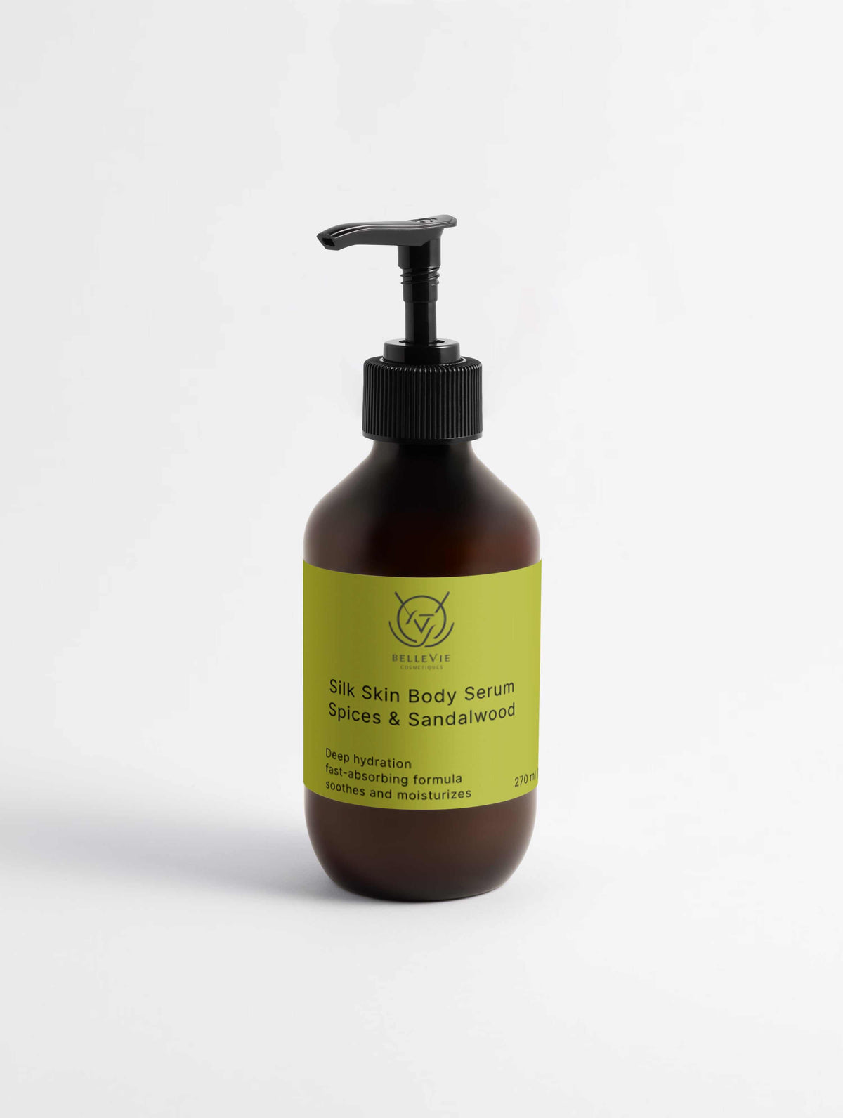 Silk Skin Body Serum in a dark amber plastic pump bottle with a bright lime-green Spices & Sandalwood label.