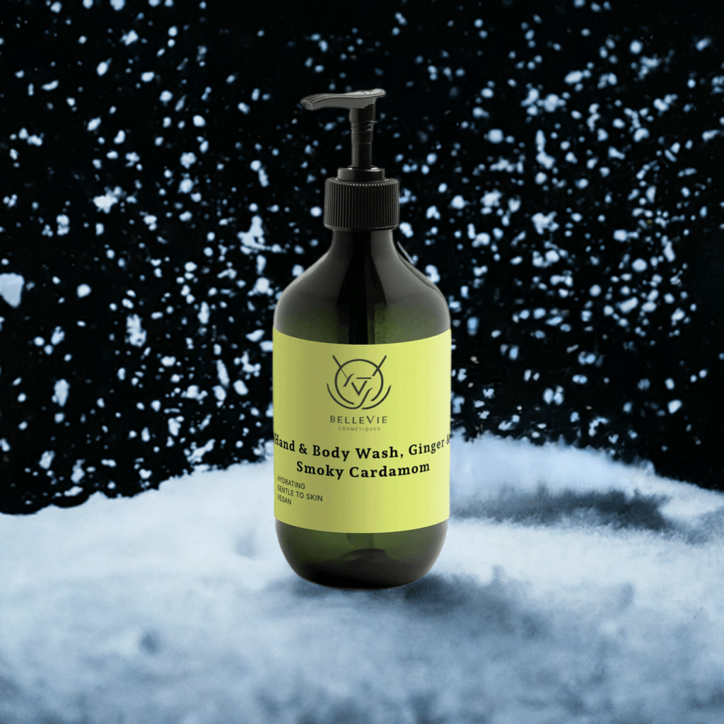 BelleVie Ginger and Smoky Cardamom Body Wash 490ml dark green pump bottle standing in snow on dark background, natural certified, allergen-free, spicy body wash UK
