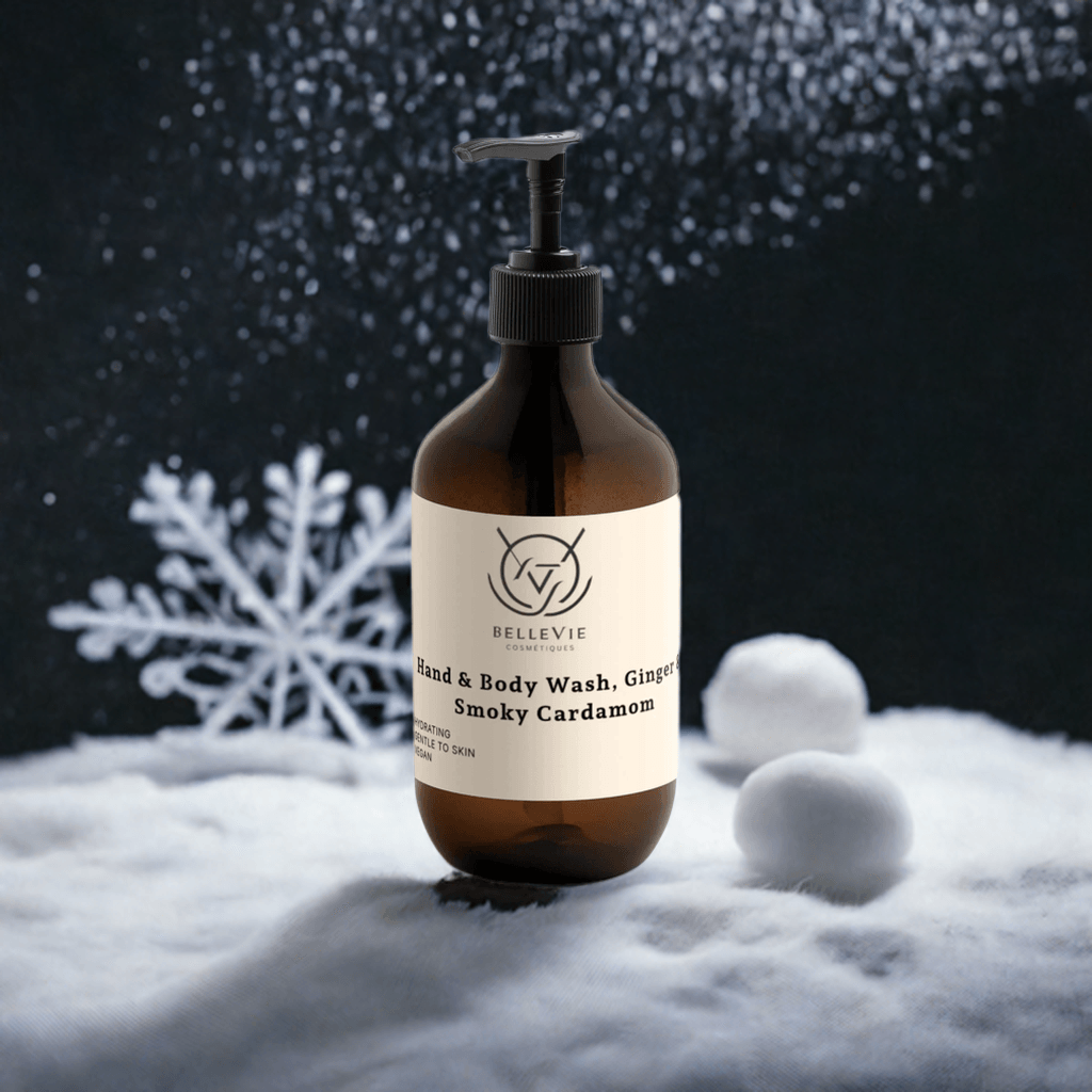 BelleVie Smoky Cardamom Body Wash 490ml amber pump bottle on dark background with glitter and snowflakes – best luxury spicy body wash UK