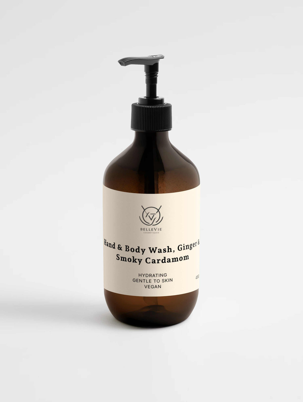 Smoky Cardamom Hand & Body Wash in an amber bottle with a cream label, black pump, and ginger-spice scent branding.