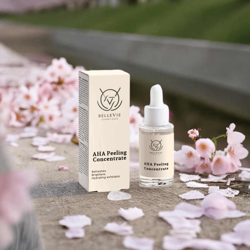 BELLEVIE AHA Peeling Concentrate bottle and box with cherry blossoms in the background