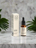 Softening Beard Oil 20ml box and bottle kept on marble with the background of leaves