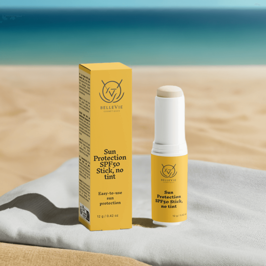 Sun protection SPF50 stick and packaging on a beach setting