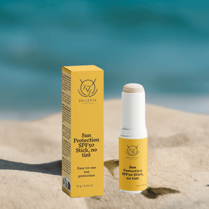 Woman applying BelleVie SPF50 Mineral Stick to her face outdoors

