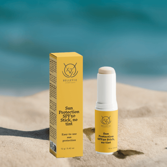 Woman applying BelleVie SPF50 Mineral Stick to her face outdoors


