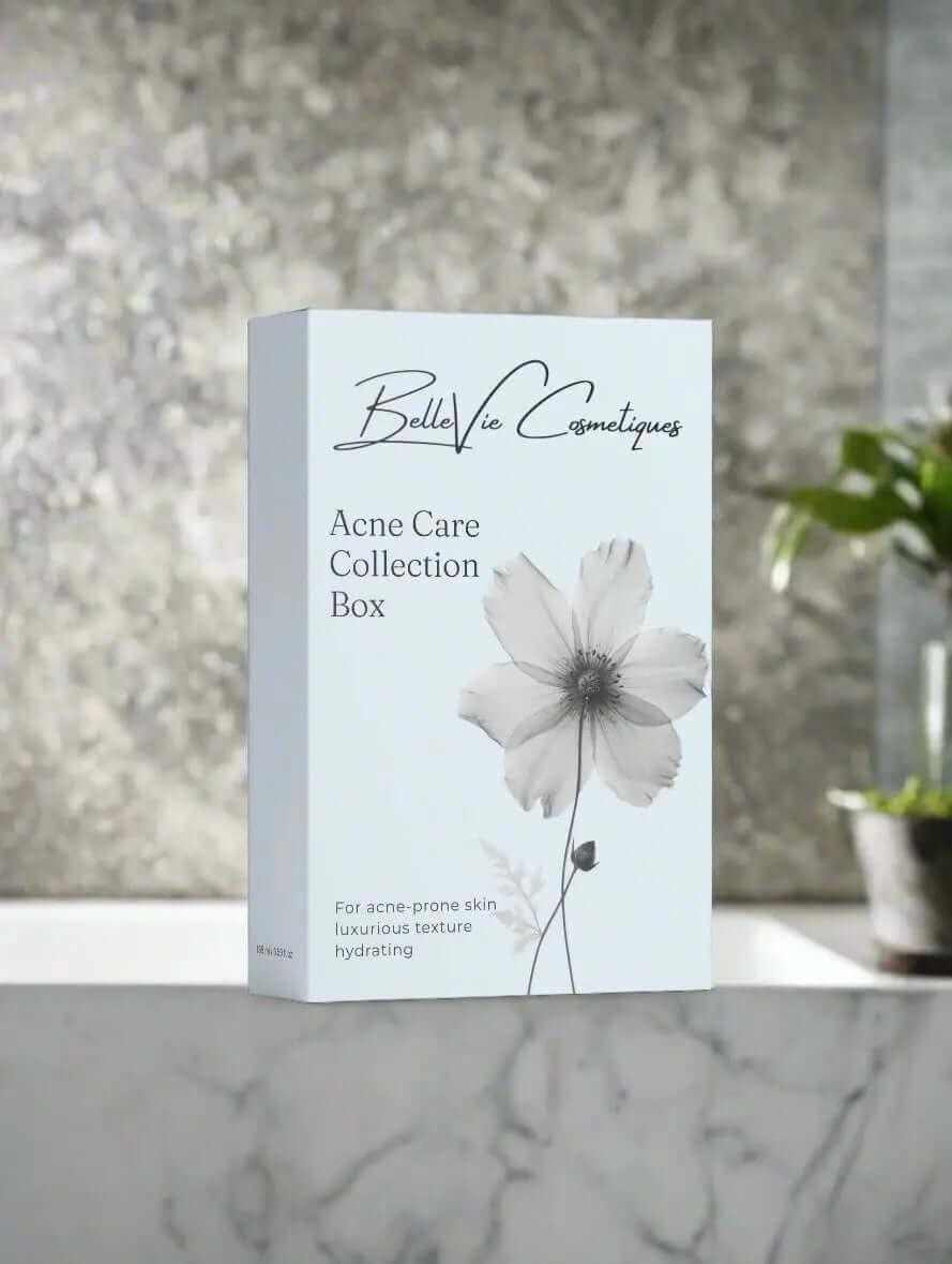 Acne Care Collection Box, pale blue skincare set packaging with elegant black lettering and a large gray flower illustration.