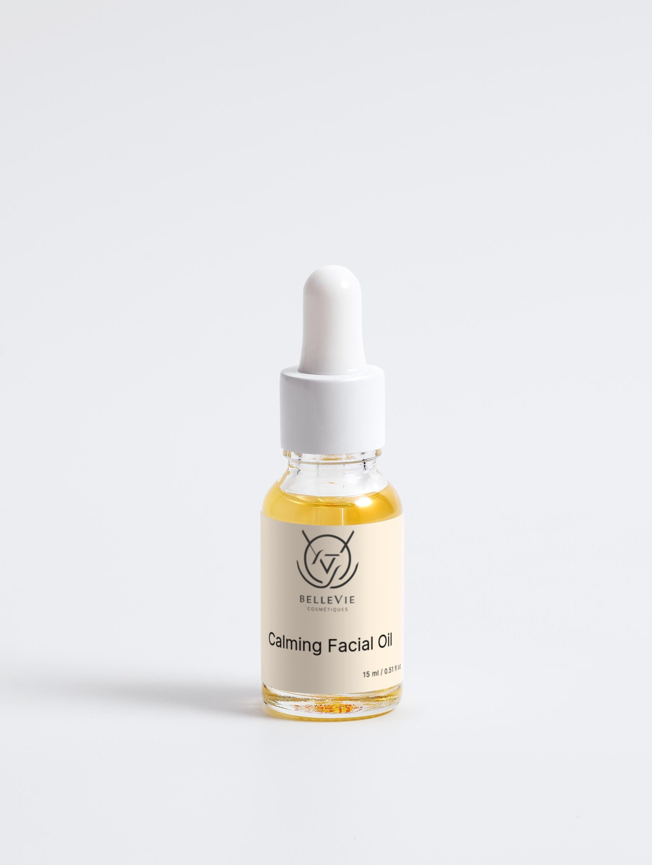 Bottle of calming facial oil with dropper on a white background