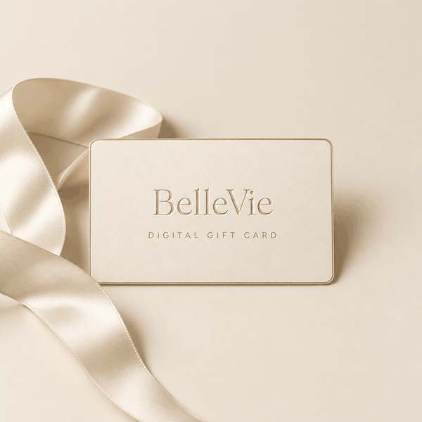 BelleVie Digital Gift Card shown as a cream card with gold lettering and a subtle gold border, beside a satin ribbon