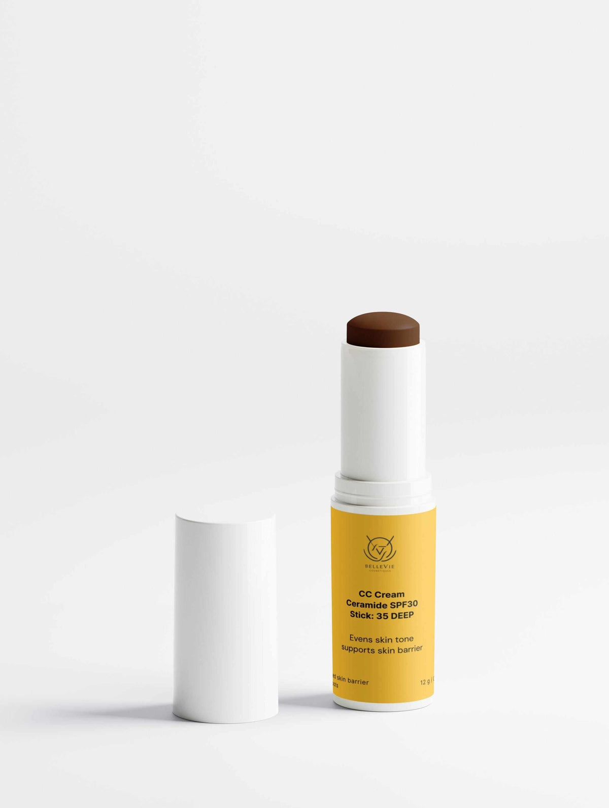 CC Cream Ceramide Stick in a yellow tube with exposed deep brown cream and a white cap beside it