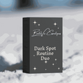 Dark Spot Routine Duo skincare set in a charcoal grey box with white lettering and star details