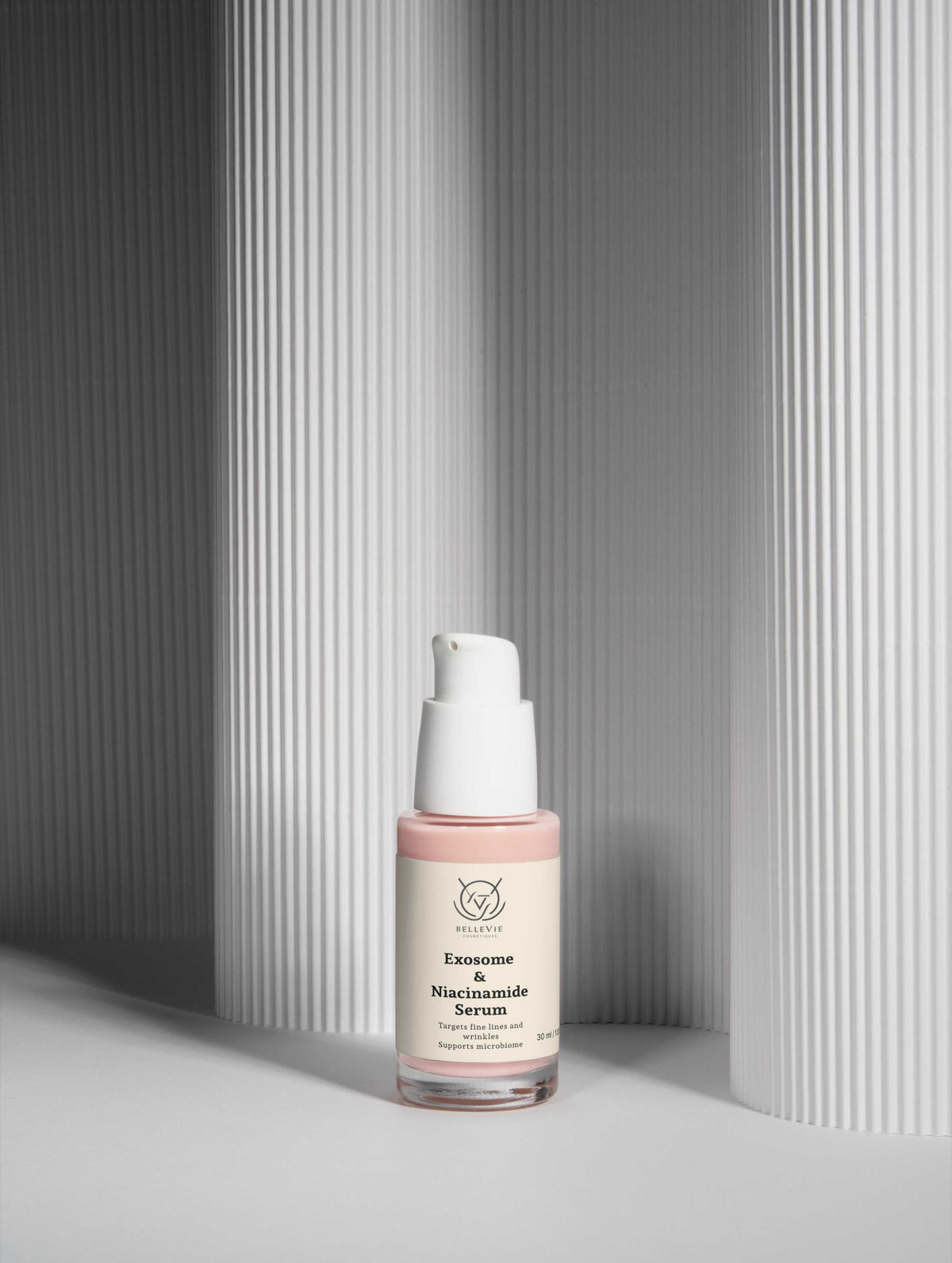 Exosome & Niacinamide Face Serum in a clear 30ml bottle with a pale pink label and white pump