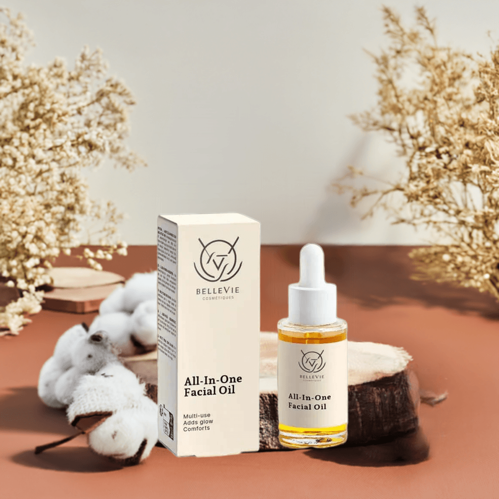 Bellevie All-In-One Facial Oil bottle and packaging on a decorative surface with flowers and coconuts.