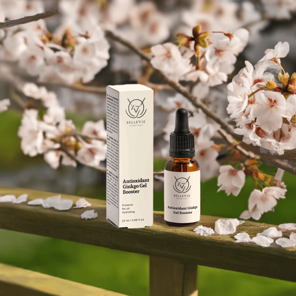 Bellevie Antioxidant Ginkgo Gel Booster bottle and box on a wooden surface with cherry blossoms in the background