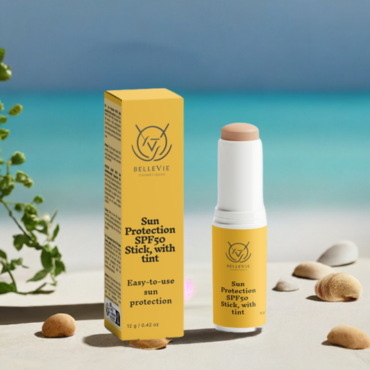 Woman applying BelleVie SPF50 Tinted Mineral Stick to face outdoors

