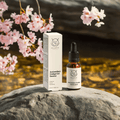 Bellevie Antioxidant Ginkgo Gel Booster 20ml bottle and packaging on a rock with cherry blossoms in the background