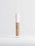 Hydrating Correcting Concealer in a clear tube with beige medium-warm product and a white cap, labeled 20 Medium Warm.