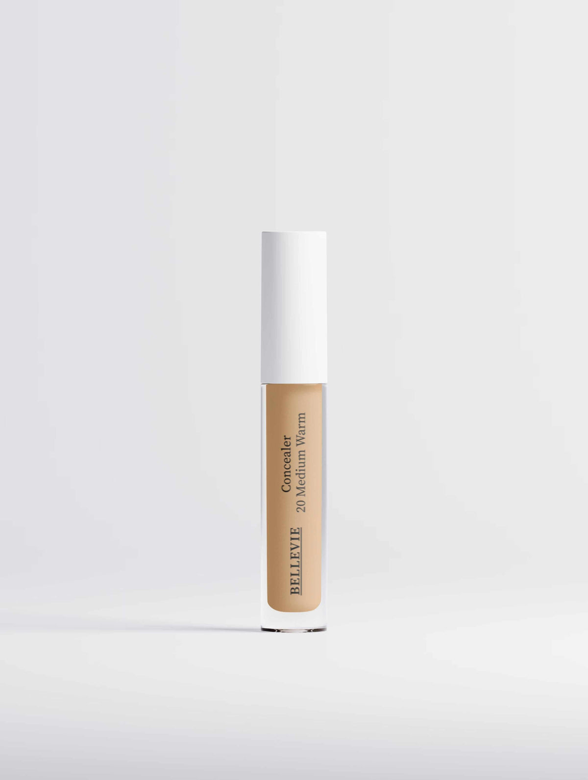 Hydrating Correcting Concealer in a clear tube with beige medium-warm product and a white cap, labeled 20 Medium Warm.