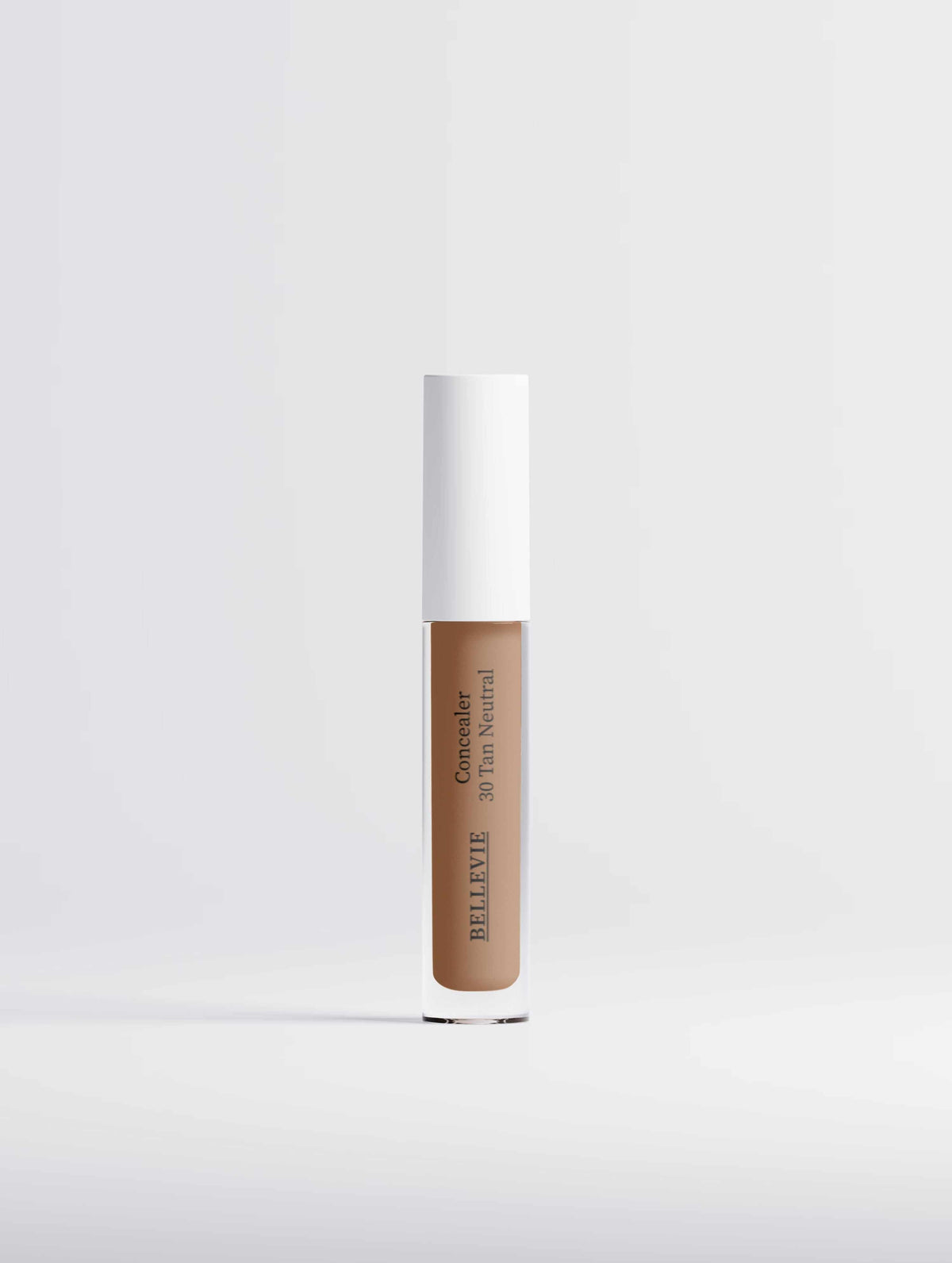 Hydrating Correcting Concealer in a tan-beige shade, shown in a slim clear tube with a white cap and printed label.