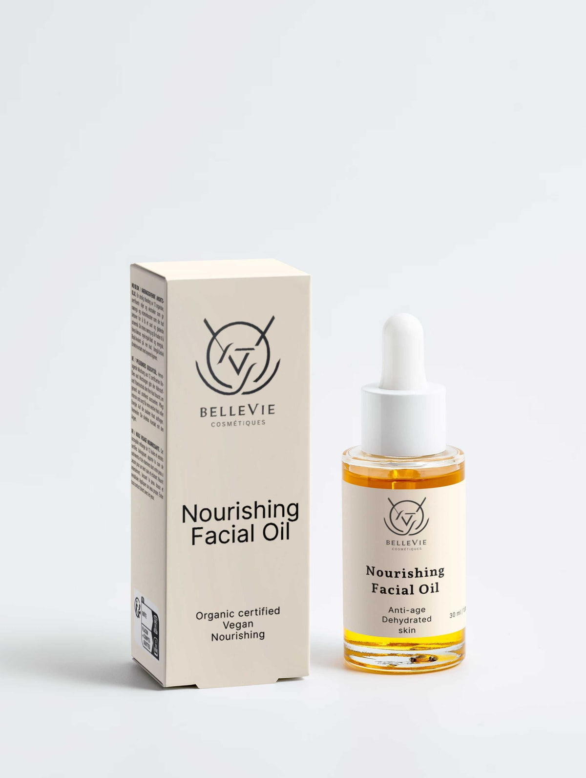 Nourishing Facial Oil 30ml in a clear amber glass dropper bottle beside cream packaging, with a minimalist label