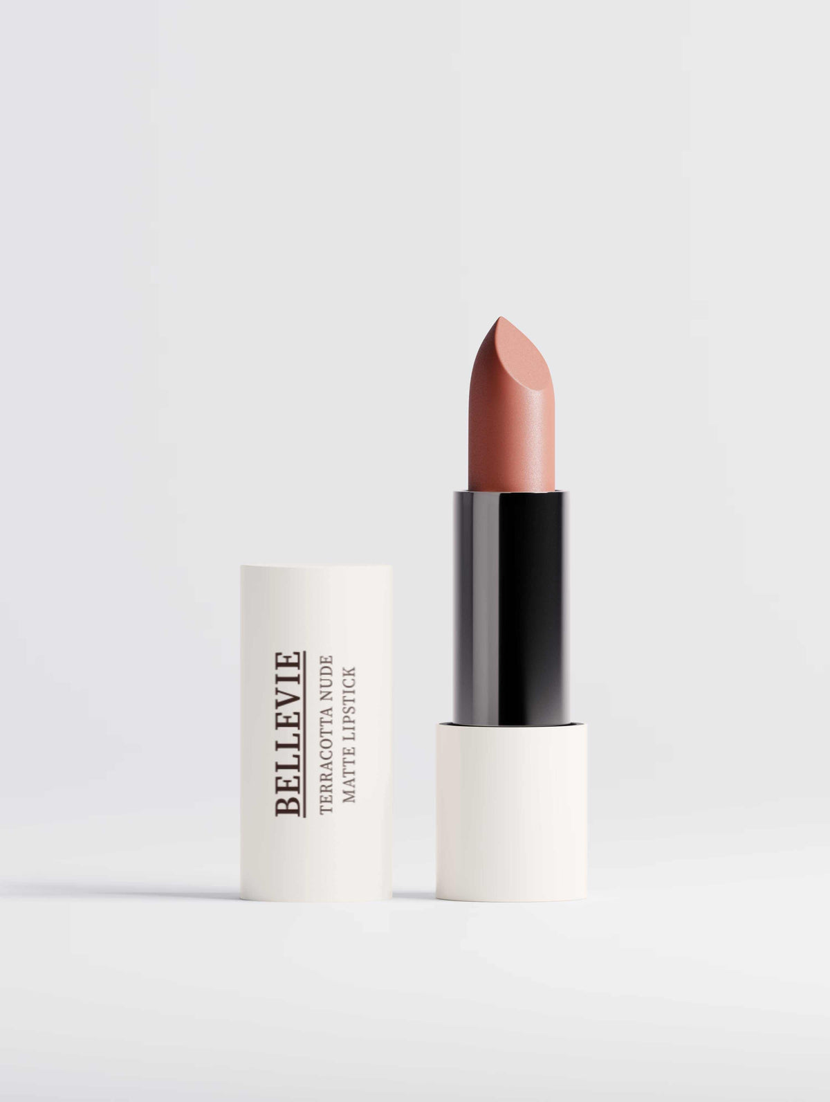 Nourishing Matte Lipstick in terracotta nude, shown as a warm peach-brown bullet with a black tube and white casing