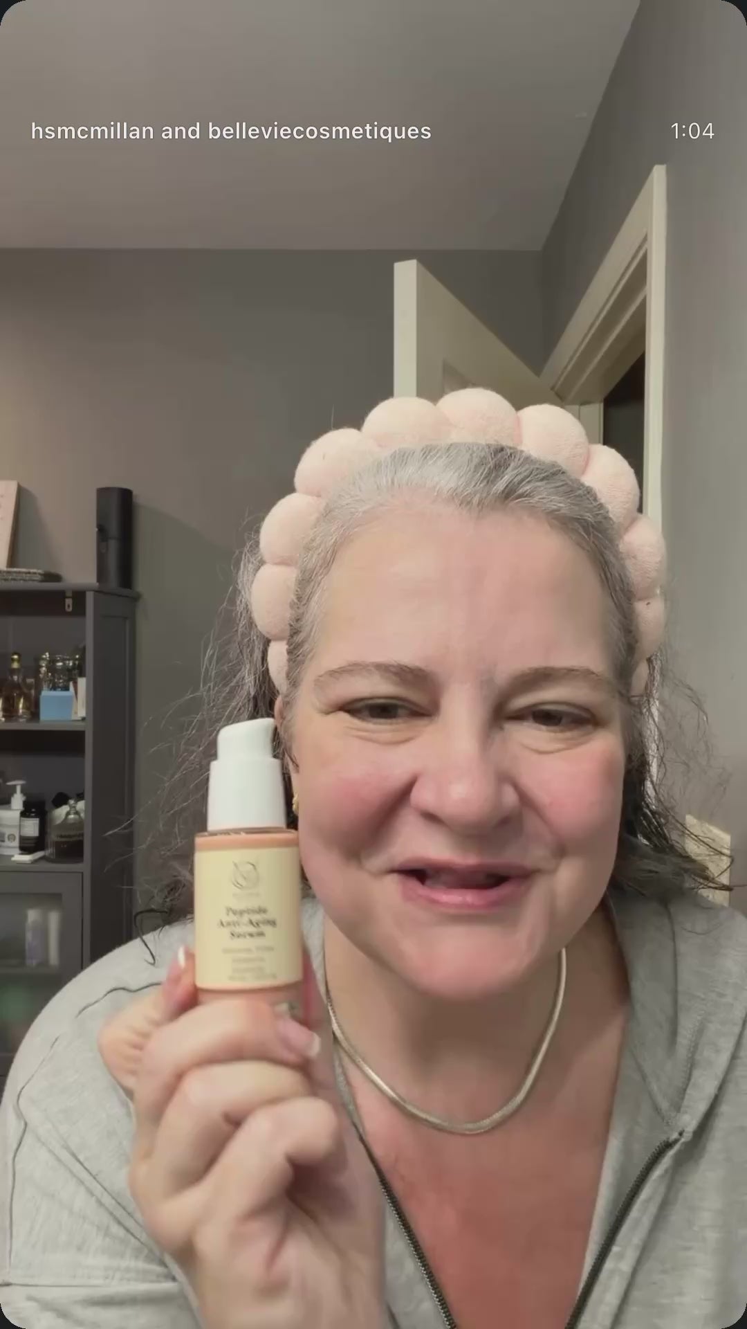 Woman holding BelleVie Peptide Anti-Aging Serum 30ml beside her face.