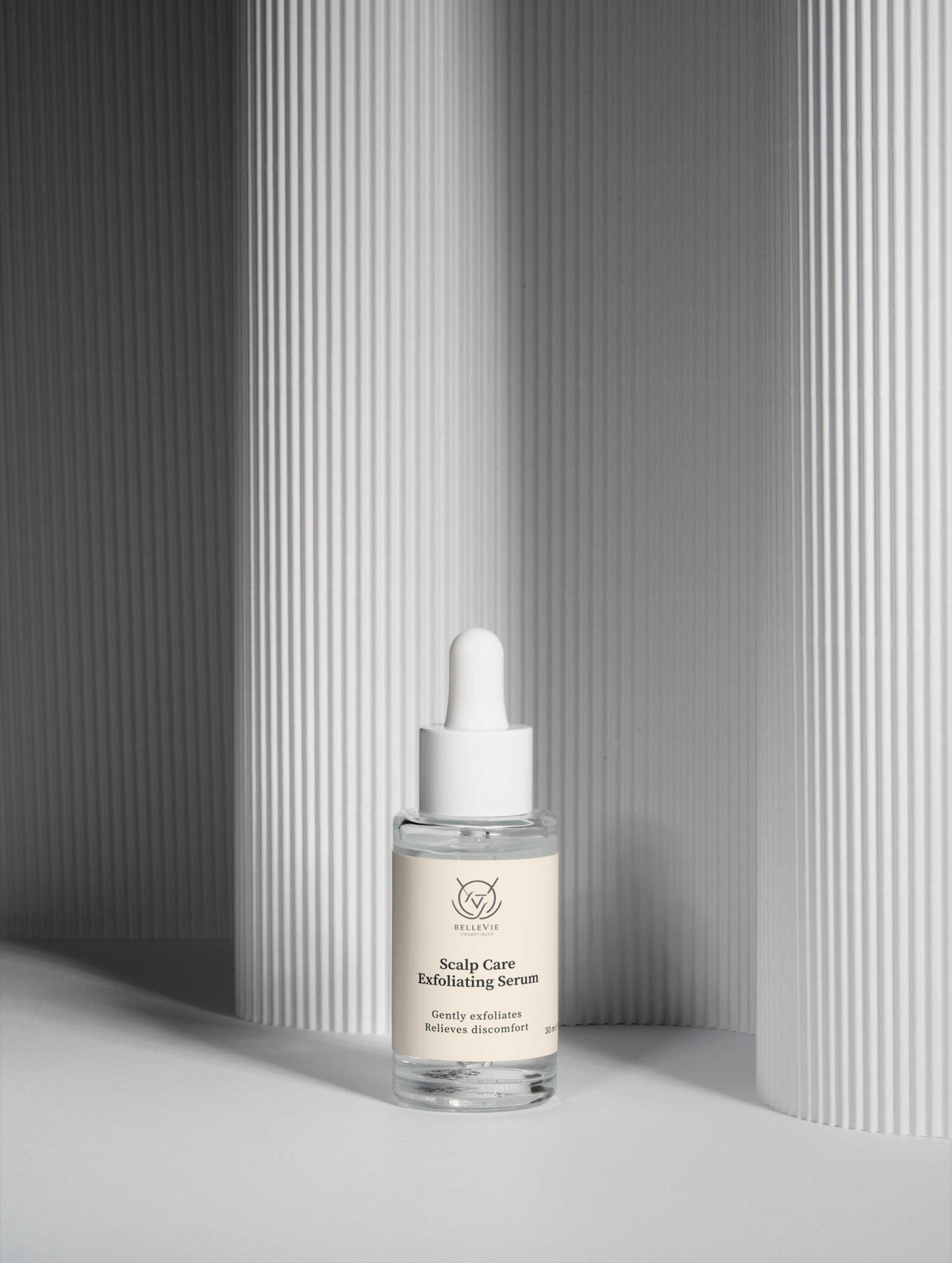 Scalp Renewal Exfoliating Serum in a clear glass dropper bottle with a white pipette cap and cream label