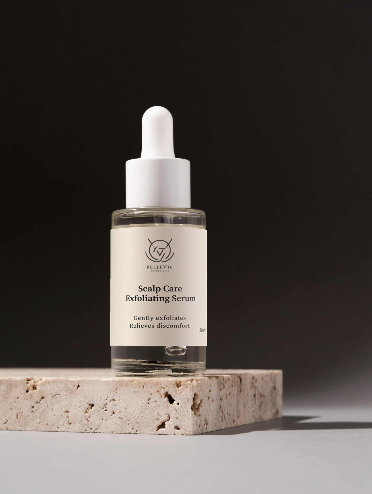 Scalp Renewal Exfoliating Serum in a clear glass dropper bottle with a white cap and cream label