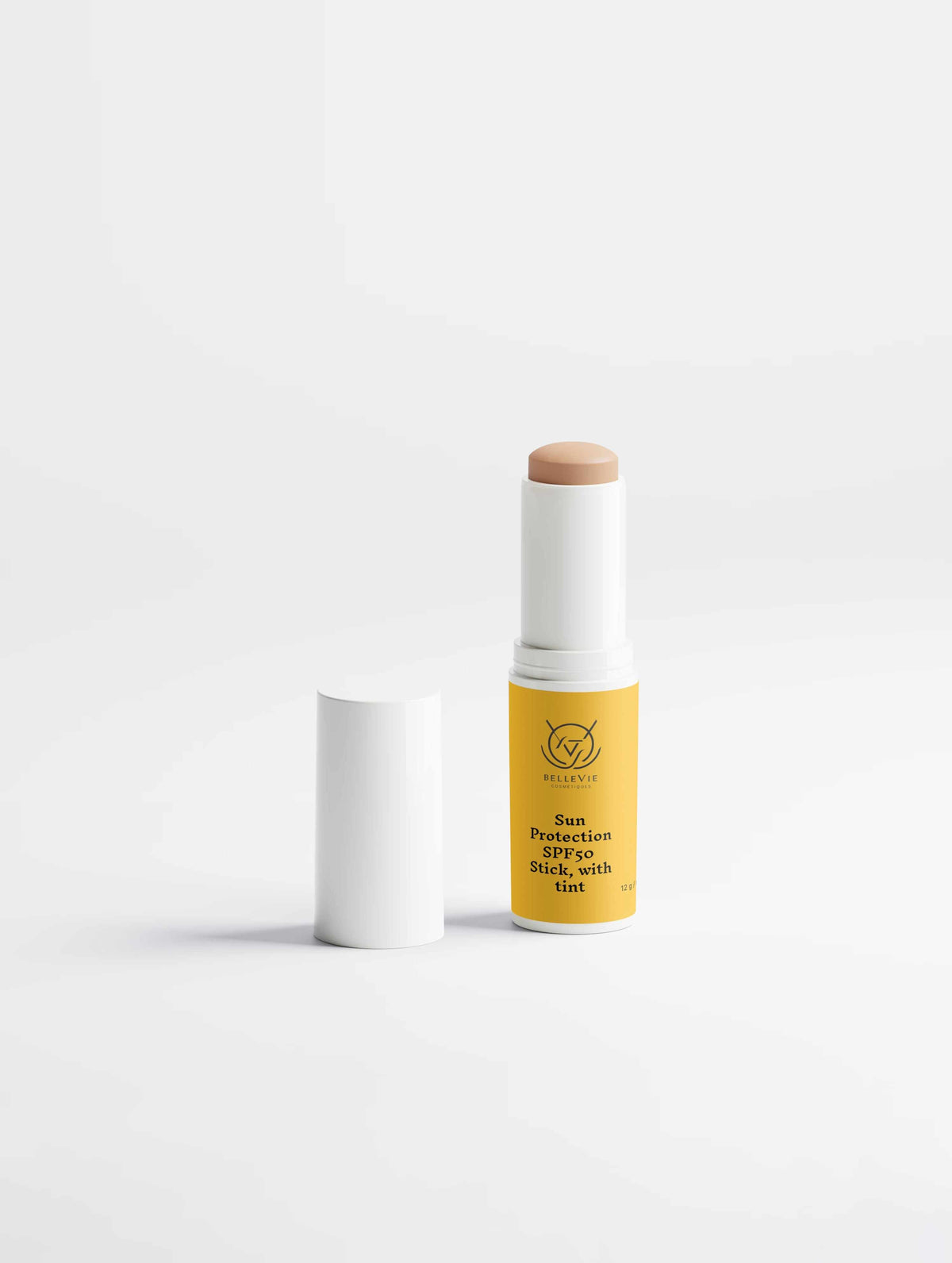 SPF50 Mineral Sunscreen Stick in a yellow tube with white casing and a beige tinted balm tip, shown with its cap.