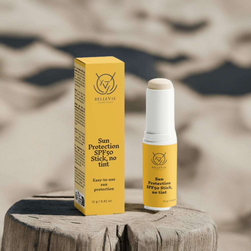 SPF50 Mineral Sunscreen Stick in a yellow tube with white cap, beside matching yellow packaging labeled no tint