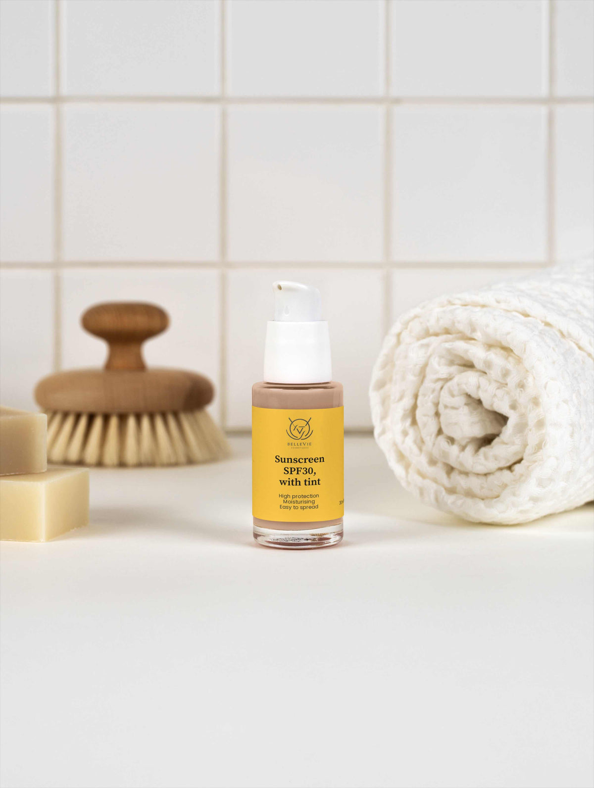 Tinted Mineral Sunscreen SPF 30 in a yellow bottle with a white pump, labeled SPF30 with tint
